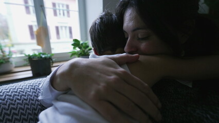Loving Mother Embracing Child for Consolation After Hardship. Parent consoles little boy with...