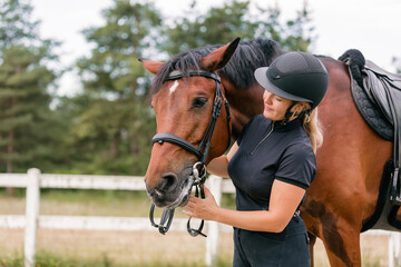 Female rider hand gently caressing beautiful thick red horse mane, close up shot. Equitation and...