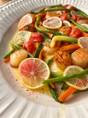 Scallops with vegetables, lemon, asparagus, carrot, zucchini