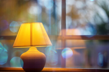 Yellow cozy lamp on a blue bokeh background.
