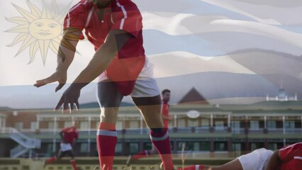 Animation of flag of uruguay over diverse male rugby players playing at stadium - Powered by Adobe