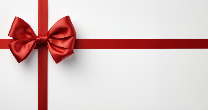 Red ribbon with bow on white background top view with copy space, banner
