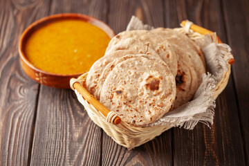 Homemade Indian Traditional Flatbread called Chapati on a dark wooden background. Baked indian...