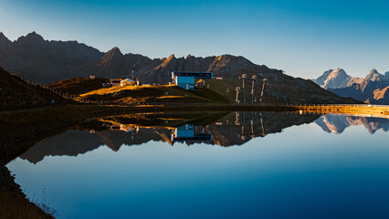 Alpine summer sunrise view with reflections in a lake at Mount Sechszeiger, Pitztal valley,...