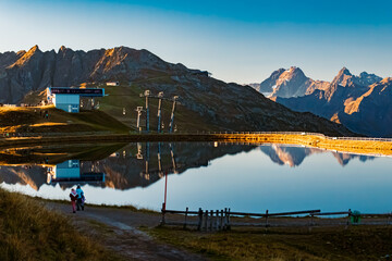 Alpine summer sunrise view with reflections in a lake at Mount Sechszeiger, Pitztal valley,...
