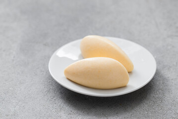 Tangerine cream dessert quenelle, on a plate. Copy space