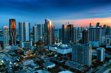 Aerial View of Miami City at Night From Building Top. Capture the stunning aerial nighttime panorama of Miami city, USA, from the top of a building.