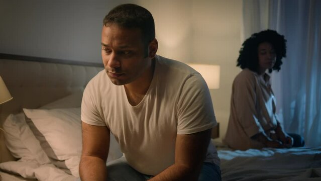 Couple family abortion problem African American man husband sad boyfriend abuse abused anxiety stress upset offended frustrated anxious woman wife girlfriend sitting on bed in night apart trouble