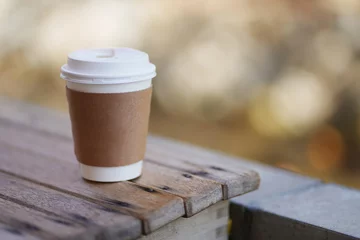 Foto op Plexiglas Take away hot drink coffee brown paper cup with isolated blurry background © JCM