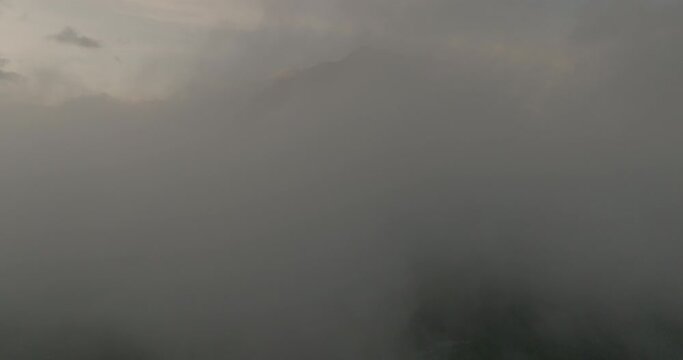 Aerial Idyllic Shot Of Tranquil Mountain Peak, Drone Flying Forward In Dramatic Clouds During Sunset - Java, Indonesia