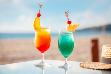 Tropical cocktails on beachside table with sea view. Summer vacation and leisure.