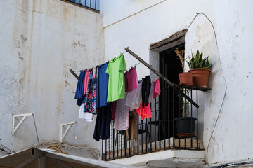 Fototapeta na wymiar Romantic backstreet, side street and alleys in historic old town of Ibiza Stadt, Balearic Island with historic Mediterranean style architecture facades, a landmark sightseeing tourist spot in downtown