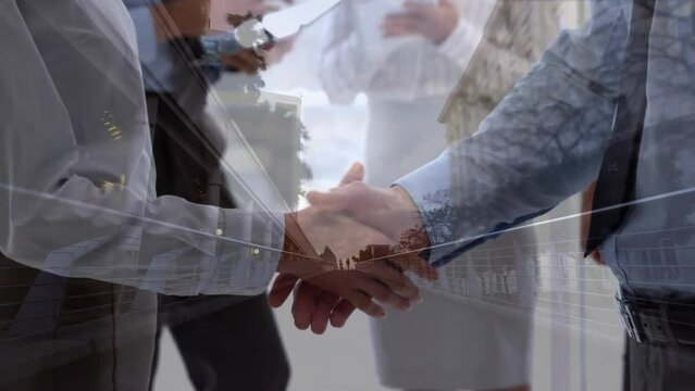 Animation of cityscape over caucasian business people shaking hands