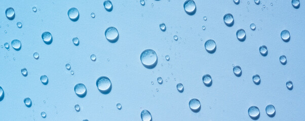 Blue drops of clear liquid, transparent water background. Moisturising cosmetics concept, spa texture. Skin care spray, beauty background Banner