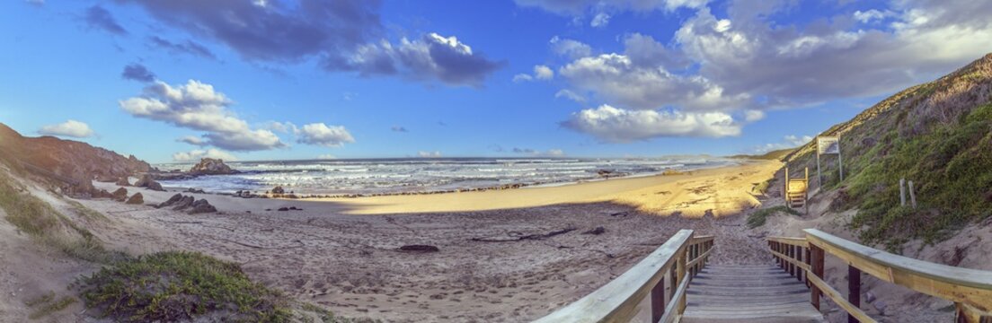 Picture of a sandy beach with access via a wooden jetty on the South African coast