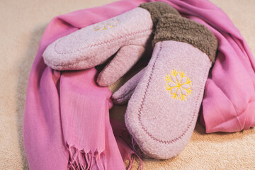 Beige winter women's leather boots and Cute pink mittens with pink Scarf. Beautiful modern Clothes for cold weather wearing. Romantic Present for girl on Saint Valentine day.