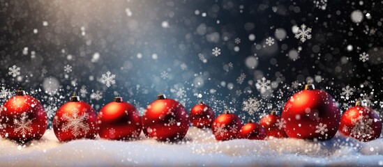 Fototapeta na wymiar Snowfall on red baubles and snowflakes.
