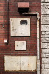 Urban electricity rusty boxes and plumbing composition.
Creative composition of weathered building services.
