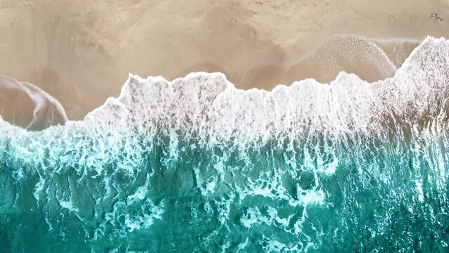 Aerial view of Scene of top view beach and seawater on sandy beach in summer. Nature and travel concept
