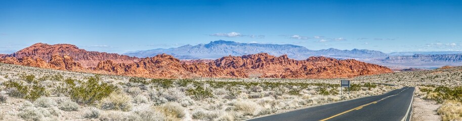 Panoramic picture of a lonely road through mountainous desert