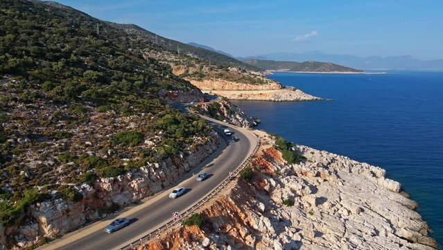 Cars on highway along Mediterranean sea coastline with sea and hills. Aerial View. Turkey