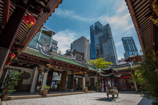 Singapore, Singapore - September 21, 2022: The Thian Hock Keng Temple in Singapore, dedicated to both Buddhism and Taoism, contrasts with the modern towers of the business district.