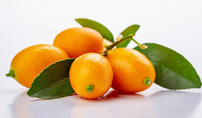 Kumquat with leaves on white background