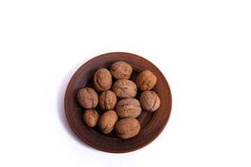 Walnuts are on a plate. Isolate. Ingredients. Diet and weight loss. Vitamins.