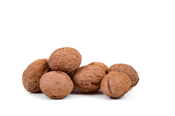 Scattered whole walnuts lie on a white background. Backgrounds and textures. Isolate.