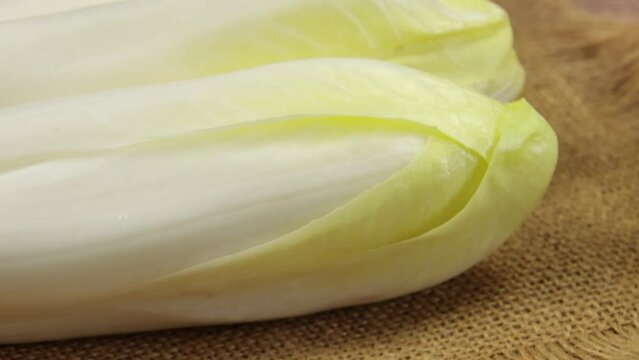 plusieurs endives crues, en gros plan, sur une table