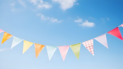 Obraz premium Colorful party pennants chain, garland with flags, on background of a blue sky