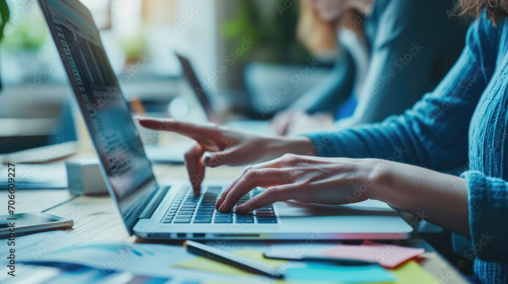 Poster person is typing on a laptop with lines of code visible on the screen