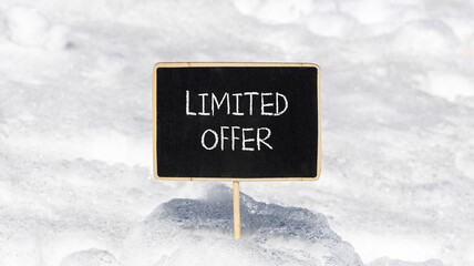 Limited offer symbol. Concept words Limited offer on beautiful black chalk blackboard. Beautiful white snow background. White snow. Business marketing motivational Limited offer concept. Copy space.