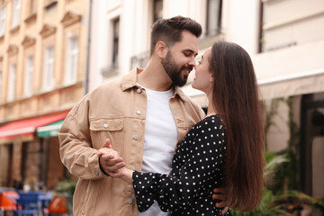 Naklejka premium Lovely couple dancing together on city street