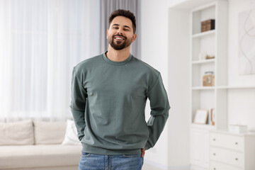 Happy man in stylish sweater at home