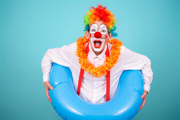 Funny clown and different situations. A happy guy is waiting for a vacation. Blue background.