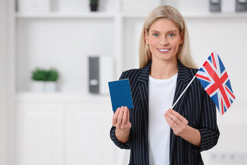 Immigration. Happy woman with passport and flag of United Kingdom indoors, space for text