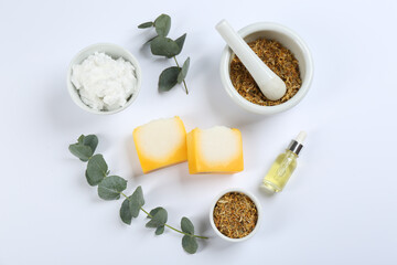Flat lay composition with natural handmade soap and ingredients on white background