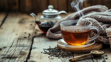 Foto op Plexiglas steaming cup of Earl Grey tea sits on a rustic wooden table, surrounded by loose tea leaves, a vintage teapot, and a cozy knitted blanket © Tom