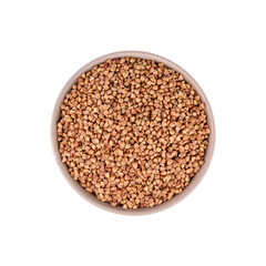 Raw buckwheat in bowl isolated on white, top view