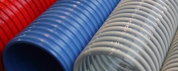 Modern colored polymer spiral pipes closeup
