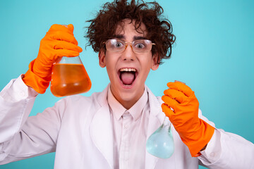 A funny doctor conducts chemical experiments with liquids. A man with test tubes. The study of the...