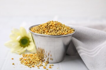 Fresh bee pollen granules on white table, closeup