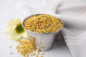 Fresh bee pollen granules on white table, closeup