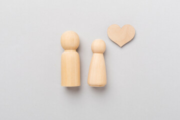 Wooden couple in love on color background, top view. Creative valentine's day composition