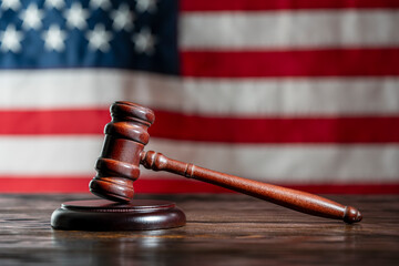 Wooden judge gavel and soundboard on the American flag background, closeup