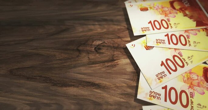 Israel Shekel banknotes on the wooden table. Israel ILS currency paper notes 3D concept background. Seamless and looped.