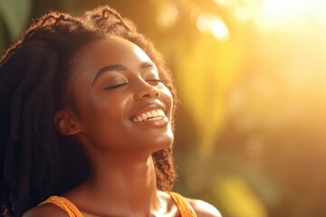 Serene young woman with afro hair in golden sunlight
