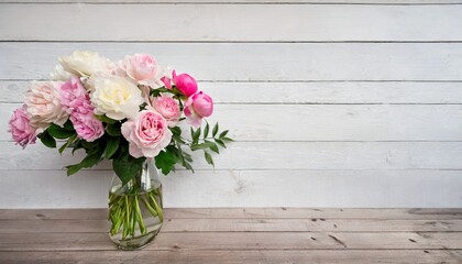 flowers in a vase peonies and roses soft pastel color on wooden background beautiful composition...