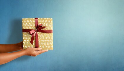 christmas background with hands holding present box background beautiful gift box on color background